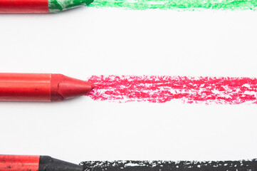 Kid's drawn rainbow and colorful crayons on white background
