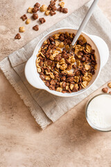 Tasty and healthy breakfast. Chocolate and vanilla cornflakes with milk in a white bowl top view. Breakfast cereals.