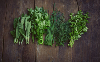 fresh herbs on wooden surface
