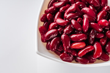 canned red kidney beans on a white acrylic background