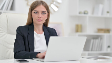 Serious Businesswoman with Laptop saying No with Head Shake 