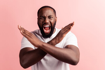 Portrait of sad man doing a break symbol crossed hands scream open mouth look camera