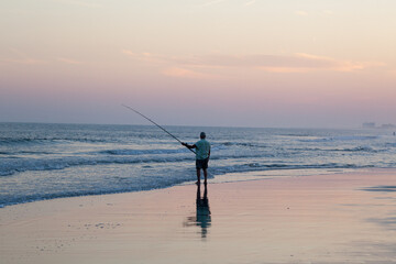 Fishing from the beach at sunrise