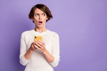 Photo portrait of clueless misunderstanding female influencer looking at copyspace isolated on pastel violet color background