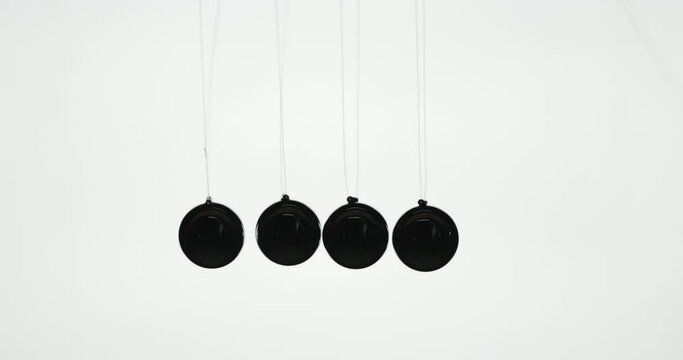 Balls in Newton's pendulum hit each other demonstrating energy conservation law