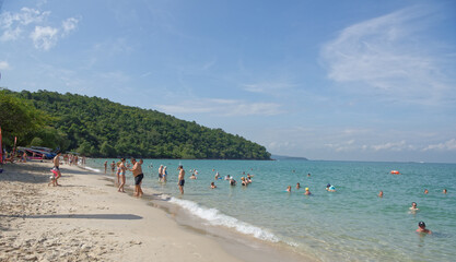  Sai Kaew Beach Sattahip- Military Beach.People sunbathe and swim.The man with the child goes to...