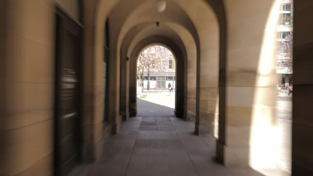 4K: Walking through Arches or Archway Timelapse - In Manchester, UK at St. Peter's Square.  Stock Video Clip Footage