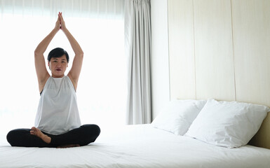 Fototapeta premium Asian women exercise by practicing yoga to stay fit.