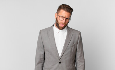 young handsome man feeling disgusted and irritated and tongue out. business concept