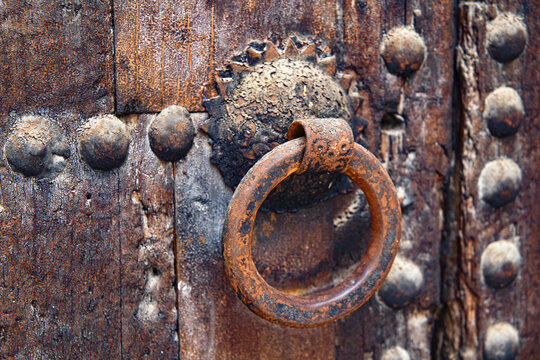 Vintage door metal knocker in the old wooden gate