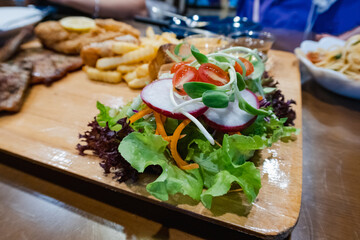 Pork steak with fries and vegetables on the food tray