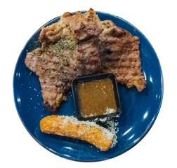 Pork steak with fries and vegetables on the food tray