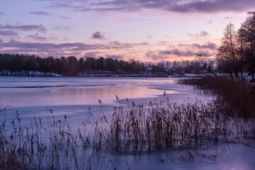 Beautiful winter landscape with lake in Trakai, Lithuania in evening time.