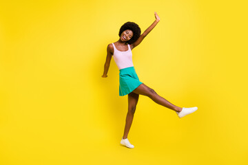 Fototapeta na wymiar Full body photo of funky afro american lady dance wear pink tank-top carefree summer isolated on yellow color background