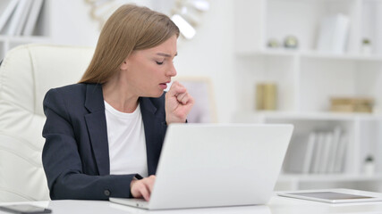 Sick Businesswoman with Laptop Coughing in Office 
