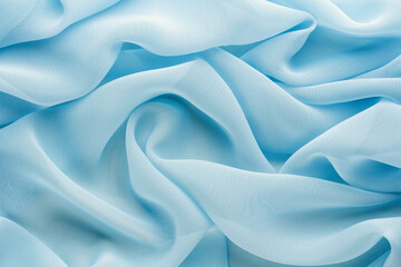 light blue fabric draped with large folds, delicate textile background