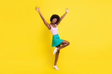 Fototapeta na wymiar Full body profile side photo of dark skin attractive young woman raise hands celebrate success isolated on yellow color background