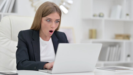 Shocked Businesswoman Reacting to Failure on Laptop in Office 