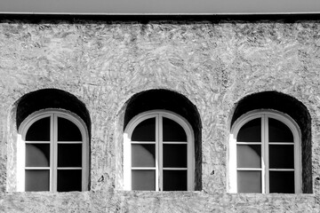 Three Arched windows on concrete facade in Spain