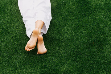 Photo of sport man sitting on grass with feet, sport relaxing concept
