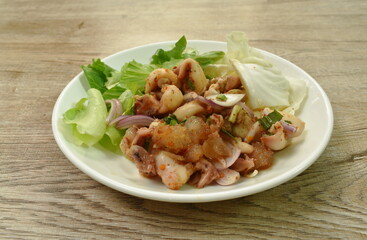 Thai spicy squid salad and fresh vegetable on plate
