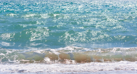 White waves of the Mediterranean on the shore.