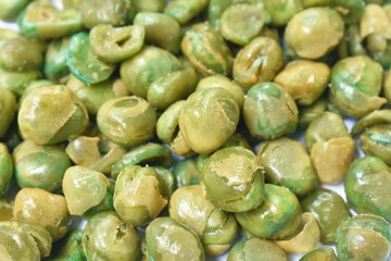 baked crispy salty garden pea arranging on white background
