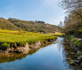 Fototapeta na wymiar A view along the Pennard Pill stream towards the Three Cliffs Bay, Gower Peninsula, Swansea, South Wales on a sunny day