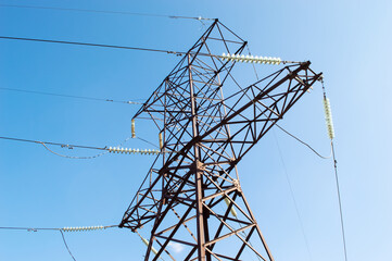 high-voltage tower against a blue bright sky