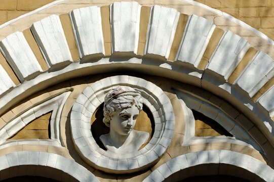 Female mascaron on old building in Kyiv Ukraine