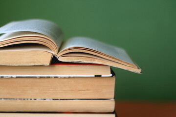 Stack of old books on a table. Selective focus.