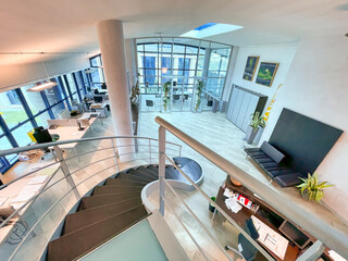 Modern office interior with stairs and desks