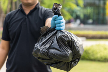 The young man separated the dangerous waste into a large black bag and put it in the trash. The...