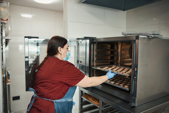 Kitchen staff being in charge of baking macarons
