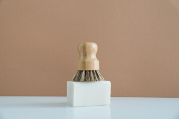 Fototapeta na wymiar zero waste bamboo brush with soap for dishwashing in minimalistic style