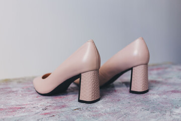 Beige fashion low heels on light backgorund.