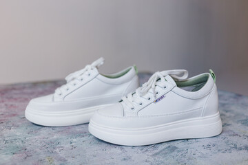 Sport white shoes on light background.