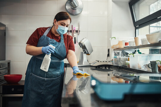 Kitchen personnel responsible for cleaning and sanitizing highly-touched surfaces