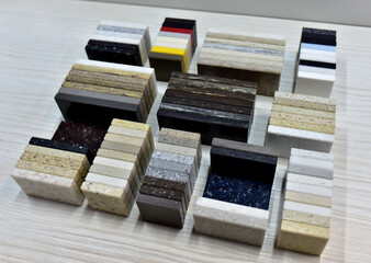 Samples of acrylic artificial stone for countertops. Artificial stone for interior decoration in the construction in houses. Quartz agglomerate or quartz agglomerate. Multicolored tiles