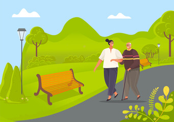 Old man leans on stick and walks with woman in park. Girl take care of man from nursing home. People stroll against background of green trees in garden. Girl smiles and helps grandfather to walk