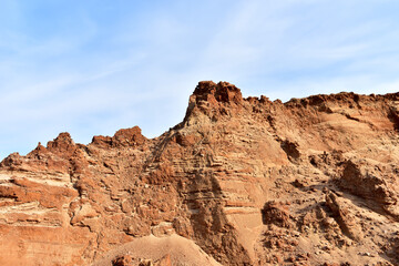 Fototapeta premium Land structure in open pit mining. Ground background in quarry. Rock texture during earthworks. Sand background and Earth's crust.