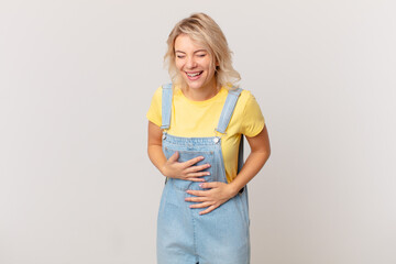 young pretty woman laughing out loud at some hilarious joke