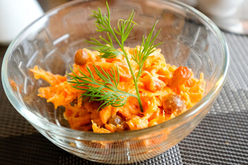 Carrot salad with raisins decorated with dill