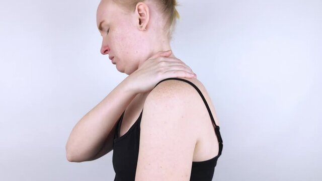 Kyphosis. The woman suffers from a curvature of the spine in the upper section. The cervical vertebrae bulge out and form a hump. Curvature and incorrect posture treatment concept