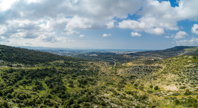 Aerial view of hills landscape with Haifa bay in background near Tamra, lower Galilee, Northern District, Israel.