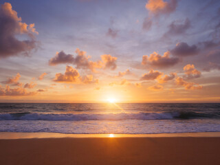 A beautiful sunset over the sea and reflection on the sand beach, taken at Mai Khao beach, Phuket Thailand.