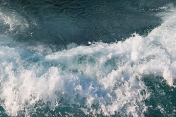 Fototapeta na wymiar waves with foam on the sea as a background