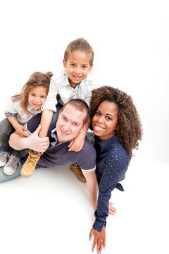 Happy multiracial family with two children, on the white background