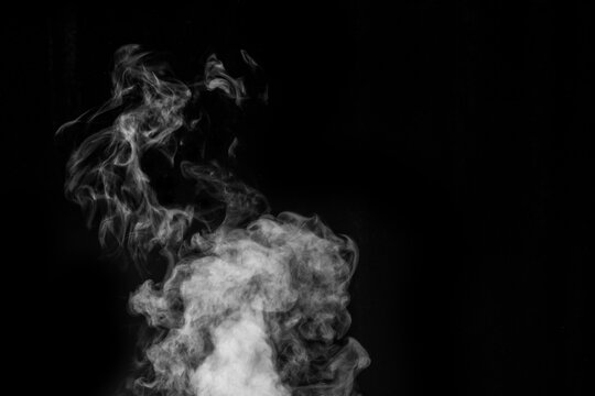 Figured smoke in the form of a mystical creature in the form of a ghost on a dark background. Abstract background, design element, for overlay on pictures