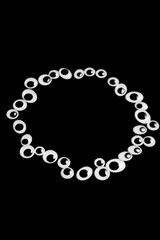 A circle of toy eyes on a black background